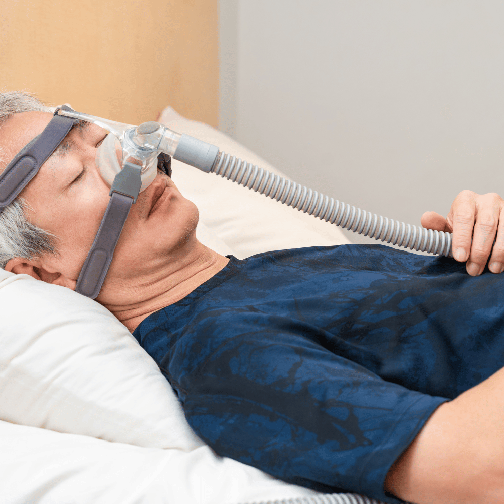 person sleeping while wearing a cpap machine