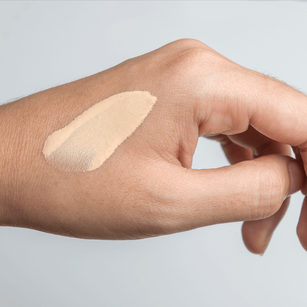 closeup picture of a woman's hand with a swatch of tinted moisturizer