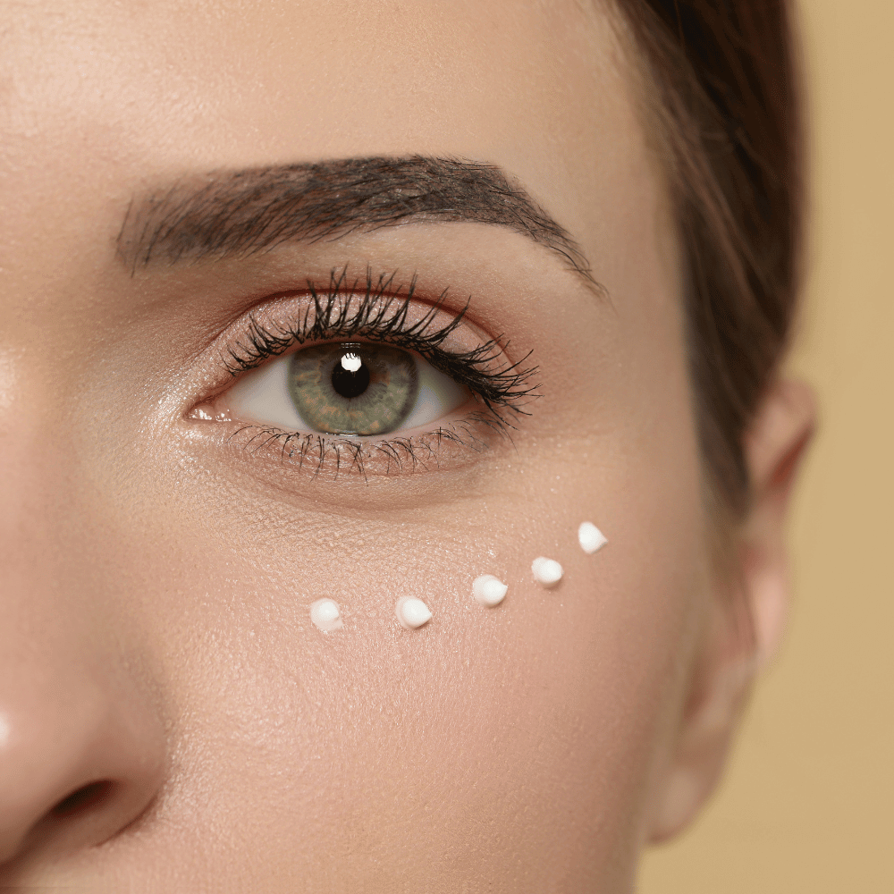 closeup of woman's eye showing small dots of eye crema on the orbital bone area