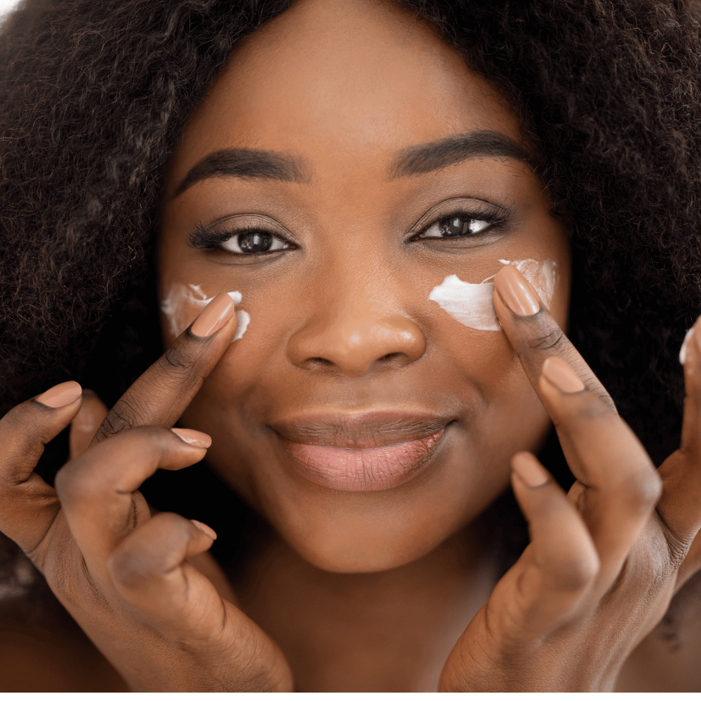 african american woman applying eye cream