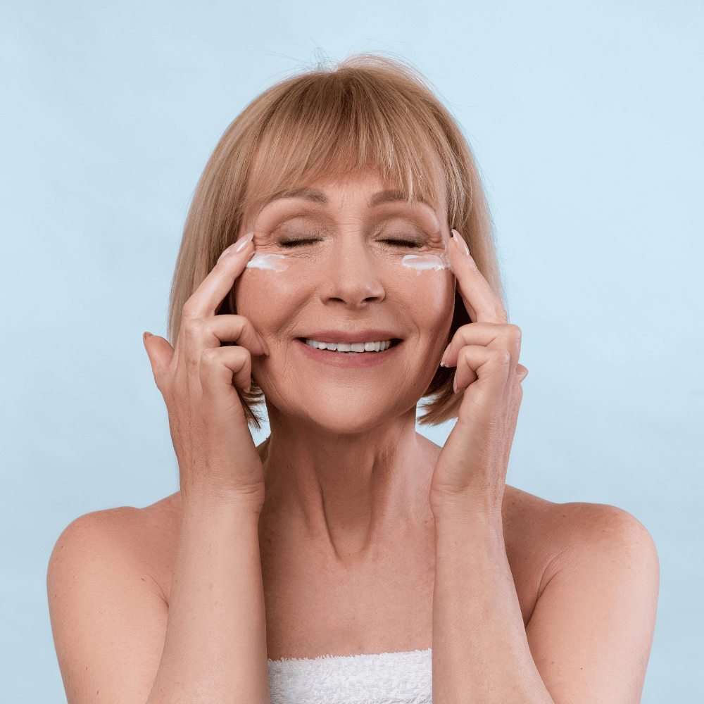 older woman applying eye cream