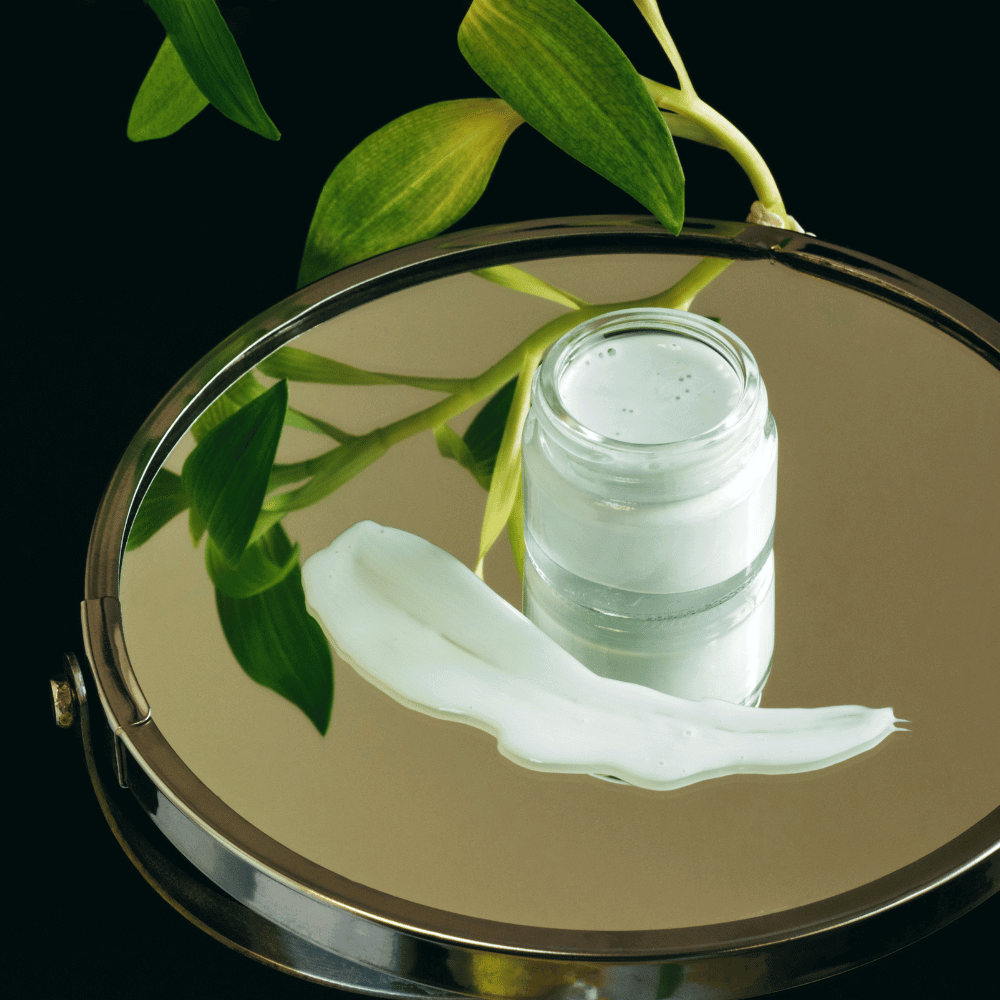 eye cream sitting on a face mirror with plant in background