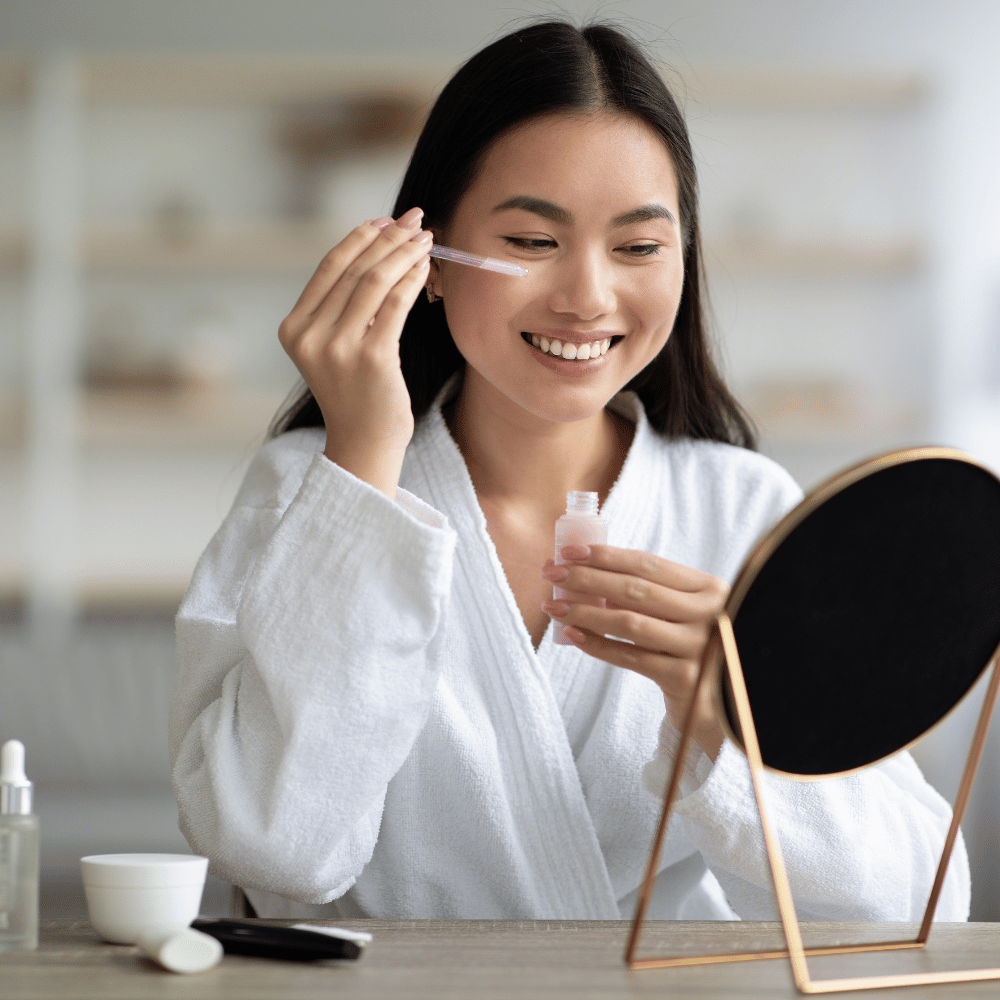 woman applying a serum to her face in her am routine