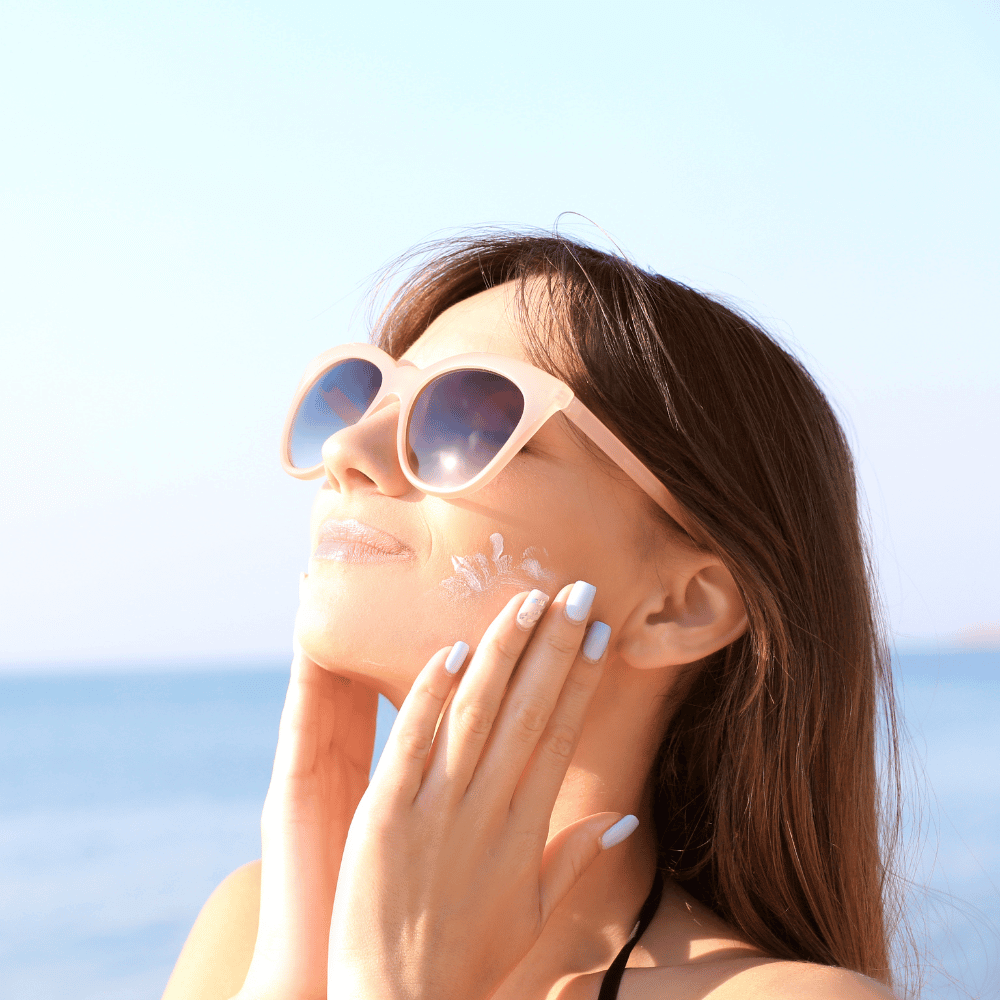 woman applying sunscreen to her face